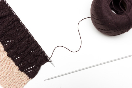Hand knitted cloth by spokes on neutral background