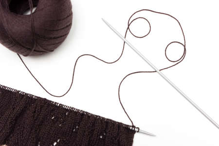 Hand knitted cloth by spokes on neutral background