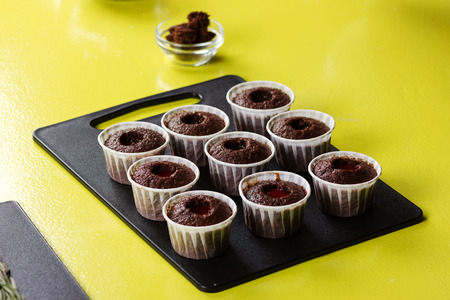Process of decorating cupcakes on the table in kitchen