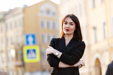 Woman in black pantsuit walks on promenadeの写真素材
