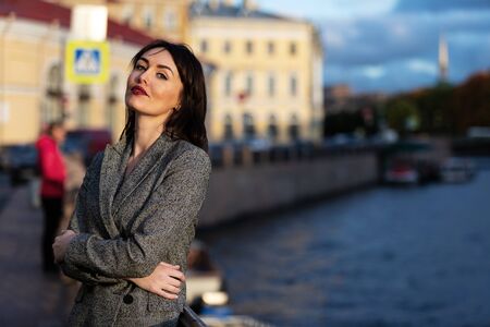 Woman in gray pantsuit walks on promenadeの写真素材