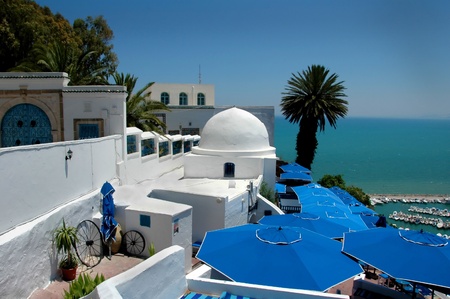 Cafe under umbrellas near the mooring line in Mediterranean Sea in Tunisia.の写真素材