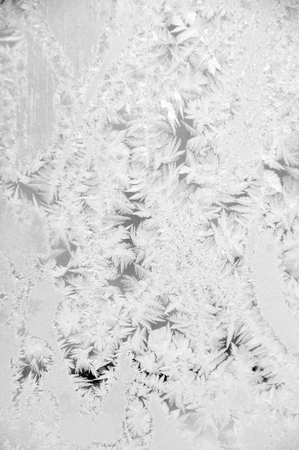 Beautiful hoarfrost ornament on window glass の写真素材