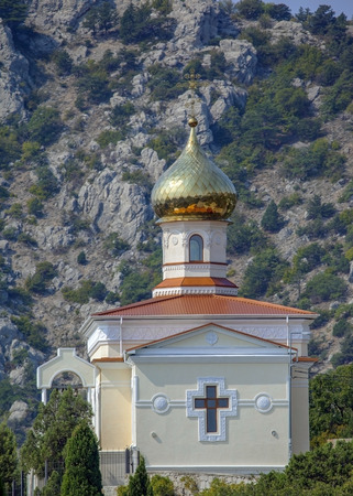 Orthodox Church against a rock in Crimean mountains の写真素材