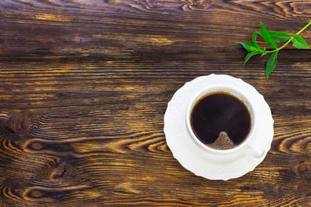 A cup of coffee on a wooden background. View from above.の写真素材