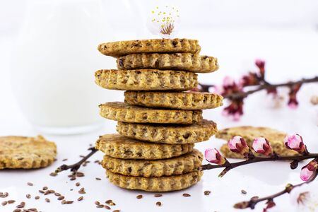 Cracker with flax seeds on a white background.