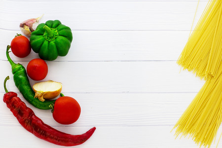Vegetables and spaghetti on white background. View from above.の写真素材