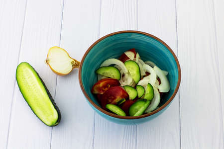Salad of tomatoes and cucumbers. White background.の写真素材