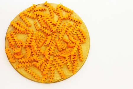 Carrots sliced on a wooden board. The background is white. View from above.の写真素材