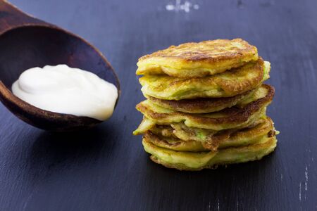 Squash pancakes on a black background.の写真素材