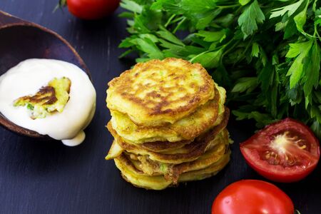 Pancakes from the zucchini. Black background.の写真素材