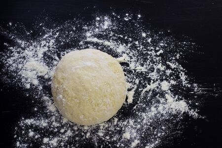 The dough is homemade. Black background.の写真素材
