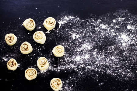 Snails with cinnamon. Black background. View from above.の写真素材