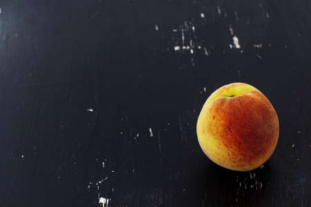 Peach on a black background.の写真素材