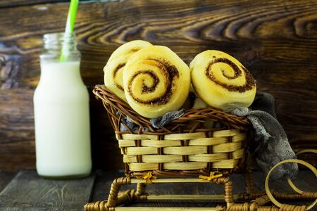 Snails with cinnamon. Wooden background.の写真素材