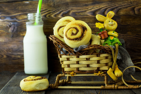 Snails with cinnamon. Wooden background.の写真素材