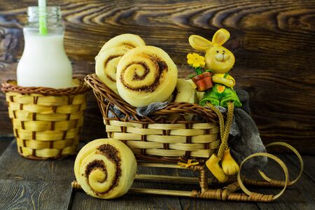 Snails with cinnamon. On a wooden background.の写真素材
