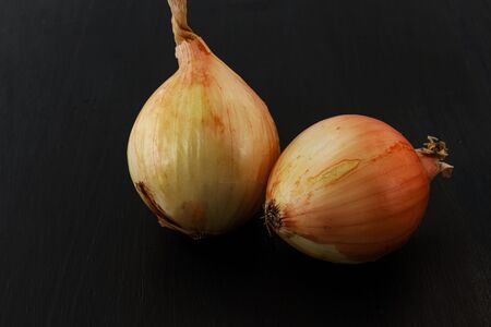 Bulb onions. Black backgroundの写真素材