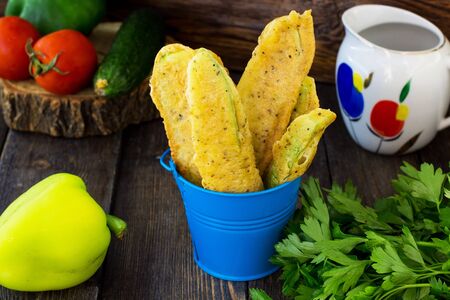 Courgettes in batter on a wooden background.の写真素材