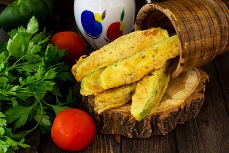 Courgettes in batter. Wooden background.の写真素材