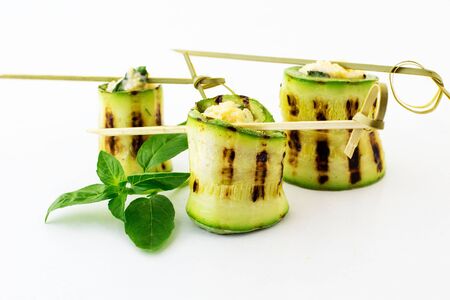 Rolls of courgettes. White background.の写真素材