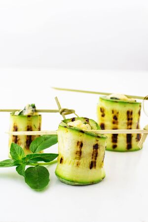 Rolls of courgettes. White background.の写真素材