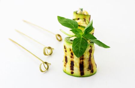 Rolls of courgettes. White background.の写真素材