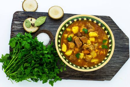 Hungarian soup goulash on a wooden board.の写真素材