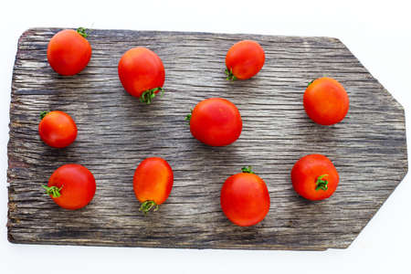 Tomatoes on a wooden board.の写真素材