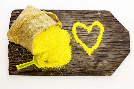 Corn cereals on a wooden board. The background is white.の写真素材