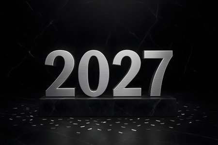 Metallic 2027 digits on black marble pedestal with scattered confetti, dramatic dark background, modern New Year celebration concept.の素材