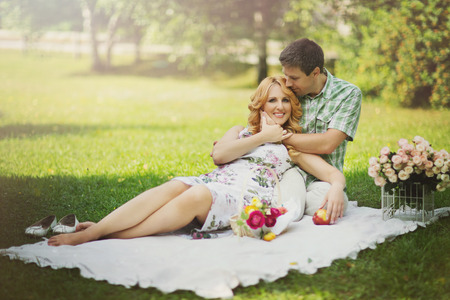 Beautiful married couple having romantic picnic outdors on summer sunny dayの写真素材