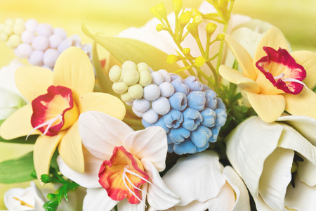 Macro view of art clay artifitial flower bouquet with narcissuses and tulipsの写真素材
