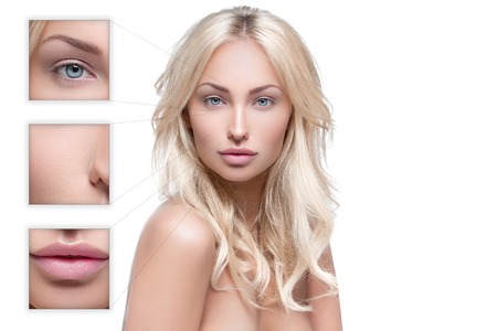 Beautiful young woman with perfect skin and wavy shiny hair isolated over white background.の写真素材