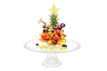 Beautiful fruit snack made in shape of tree. Isolated over white background. Copy space.の写真素材