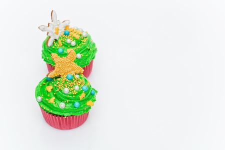 Christmas tree cupcakes over white background. Copy space.の写真素材