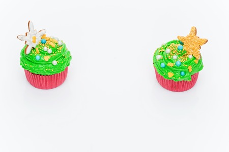 Christmas tree cupcakes over white background. Copy space.の写真素材