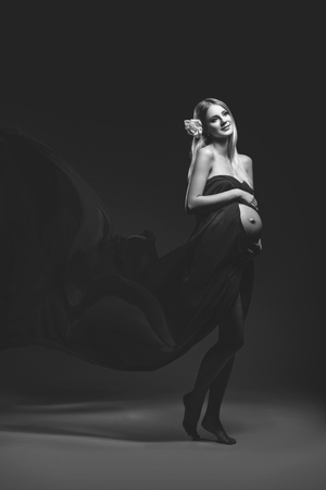 Pregnant girl in red dressの写真素材