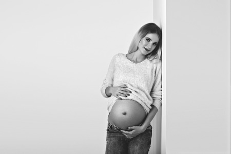 Beautiful pregnant woman in jeansの写真素材