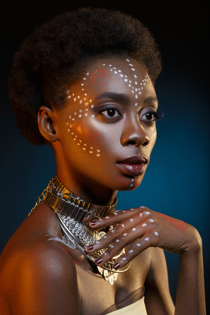 Beautiful afro girl with drawings on skinの写真素材