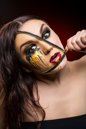 beautiful young woman with zipper on face