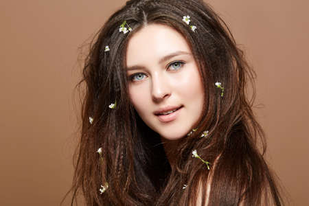 Girl with many small flowers in long hairの写真素材