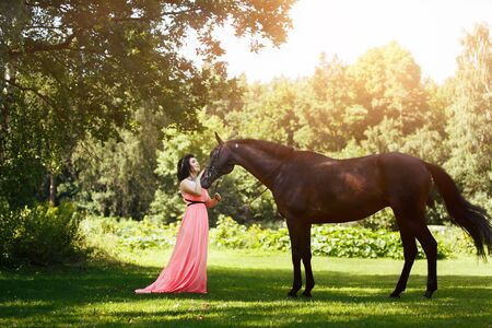 beautiful girl in dress with horseの写真素材