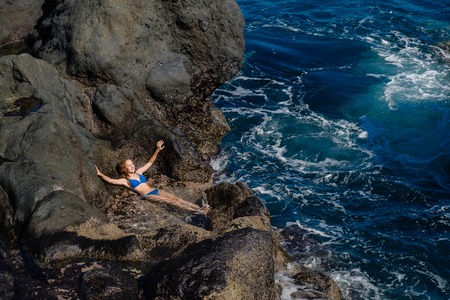 beautiful girl resting in natural ocean swimming poolの写真素材
