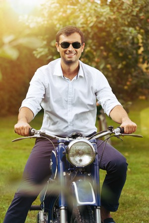 handsome man on retro motorbike