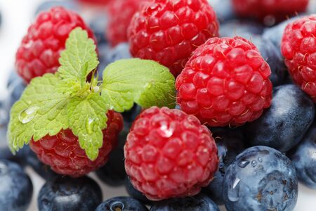 blueberry and raspberry berries isolated on white background