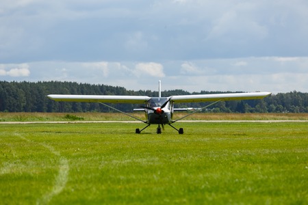 small plane on green field before take-off outdoors