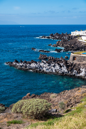 beautiful view on ocean water and santiago del teide town. outdoor shot on tenerife island. copy space.の写真素材