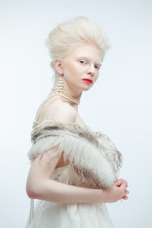 beautiful albino girl with red lips on white backgroundの写真素材