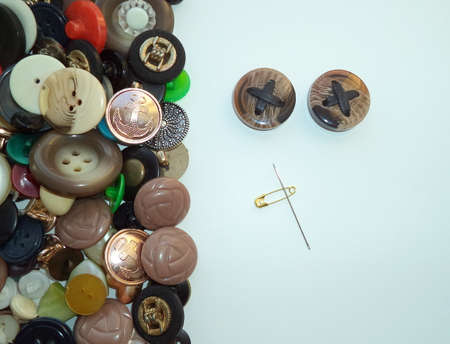 Multi-colored buttons and a safety pin for sewing.の写真素材